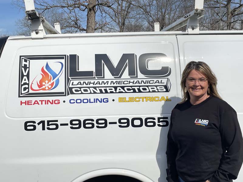 Cindy Escue Owner in front of Lanham's AC Service Company Van