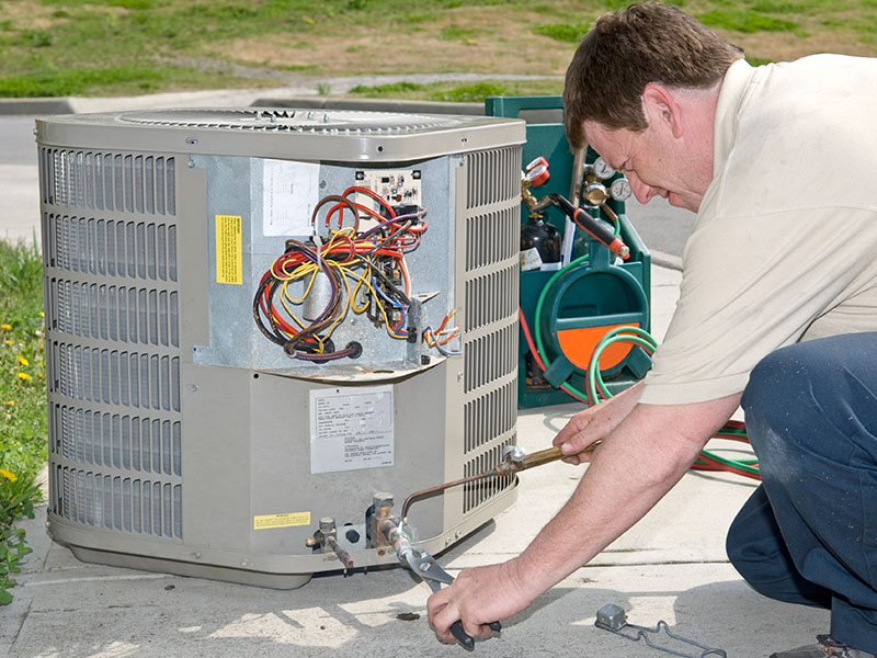 HVAC tech working on outdoor unit in Goodlettsville, TN