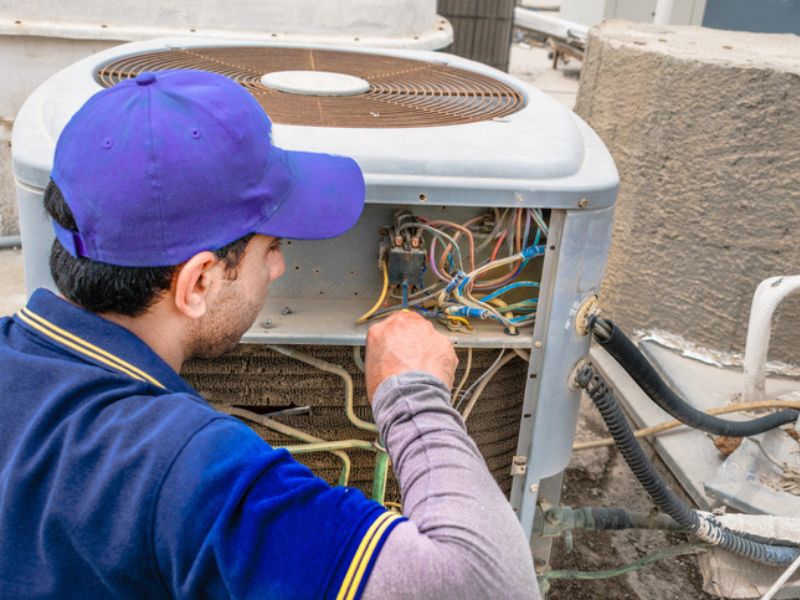 HVAC technician repairing outdoor unit for emergency call in Goodlettsville, TN