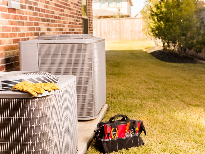 Outdoor AC units with tool bag and gloves on top of unit in Goodlettsville, TN