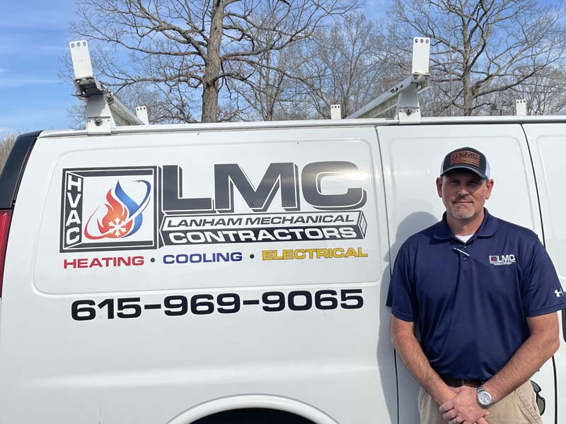 Adam Harris Adam Harris Vice President _ HVAC General Manager in front of Lanham's AC Service Company Van