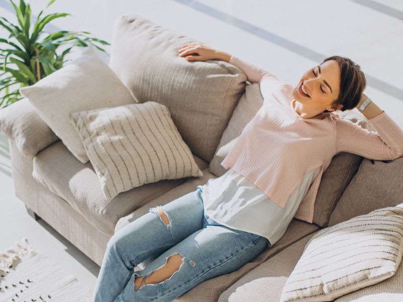 female on sofa breathing clean air