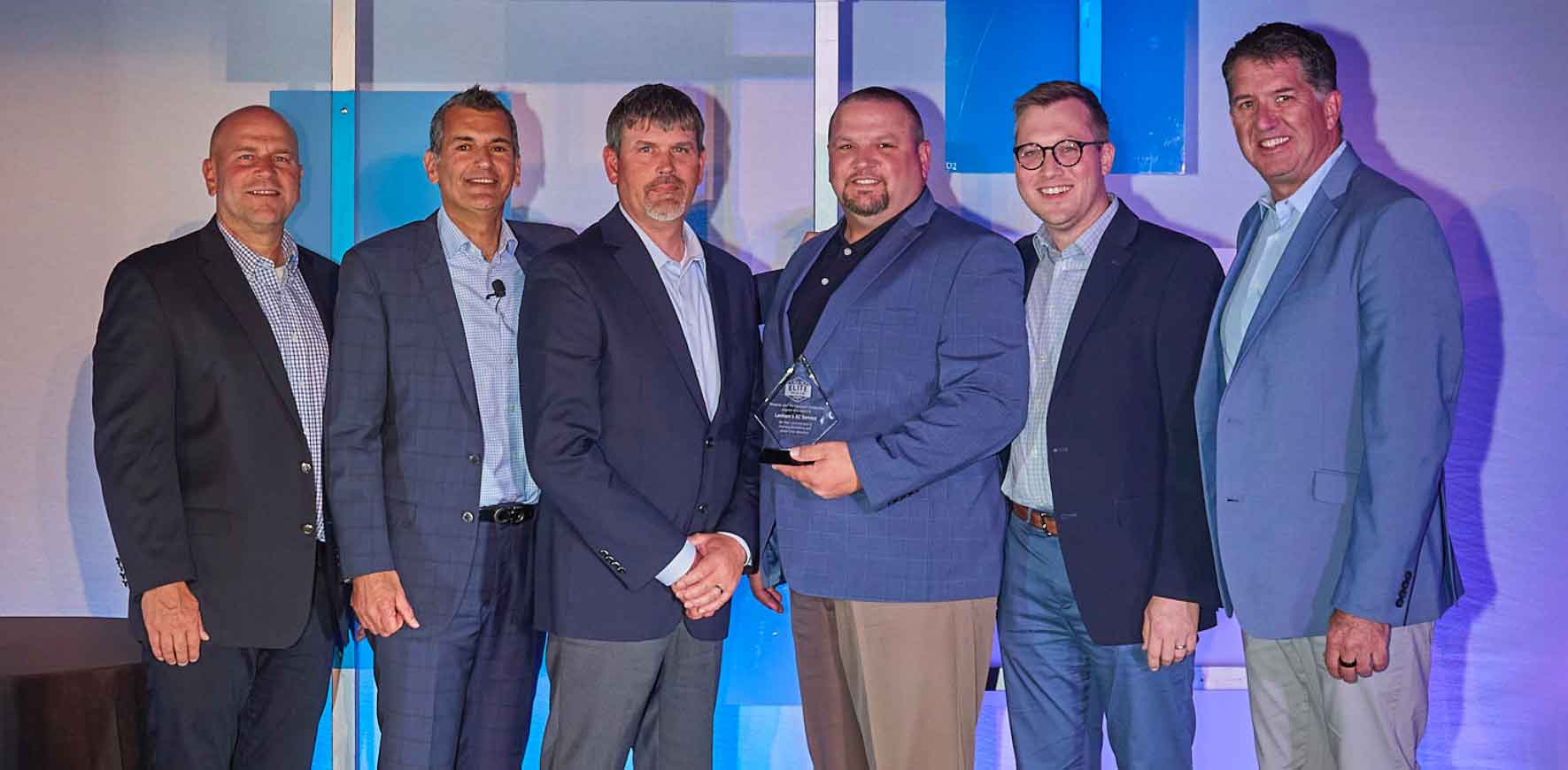 Meet The Lanham's AC Service Team receiving an award