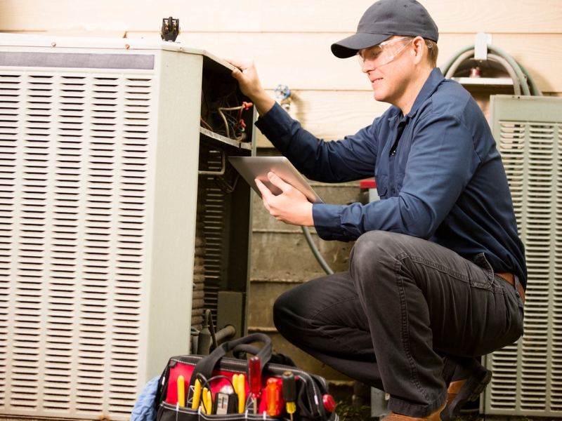 Air conditioner repairman works on home unit in Goodlettsville, TN